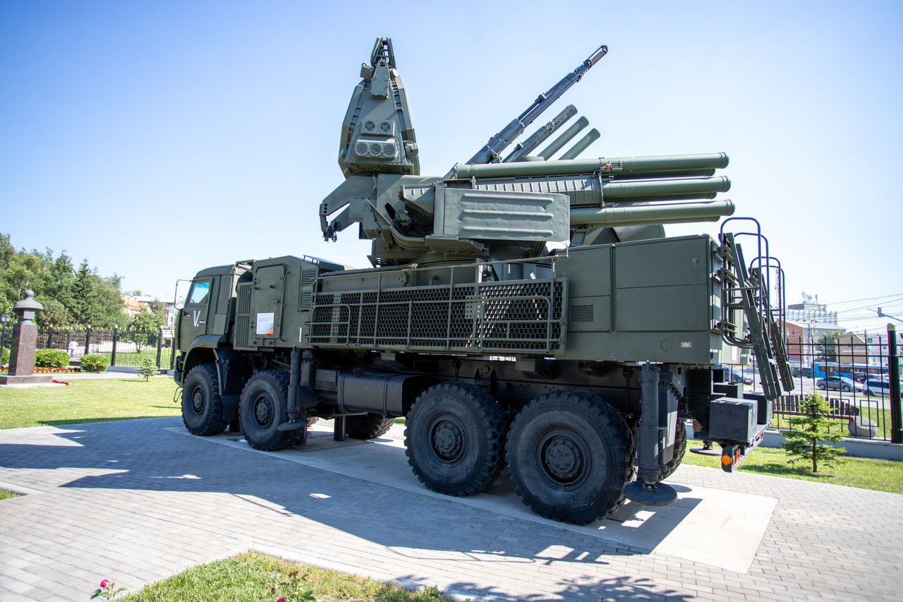services-01 Outdoor display of a military missile defense system on a sunny day, highlighting its structure.